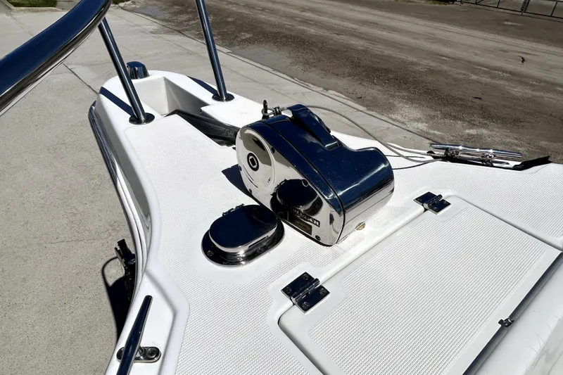 Slide: The Image of 2004 Robalo R230 Center Console boat deck with chrome fittings and winch. - 6