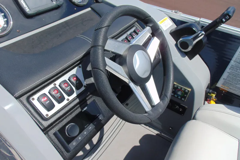 Slide: The Image of Steering console of 2020 Godfrey Monaco 235 SB boat with control panel and switches. - 11