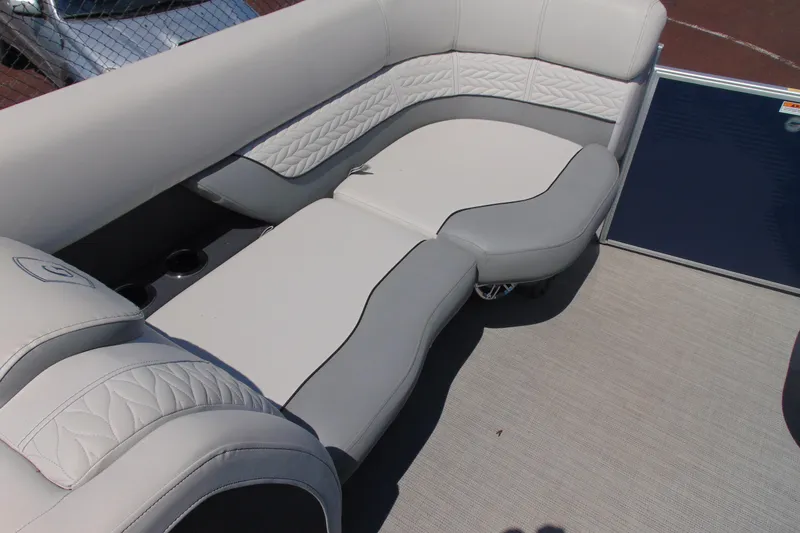 Slide: The Image of 2020 Godfrey Monaco 235 SB boat interior with luxurious white and gray seating. - 6