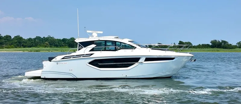 The Image of The 2024 Cruisers Yachts 42 Cantius glides on calm waters, featuring a sleek, modern silhouette. - 0