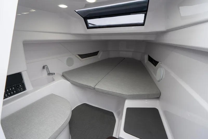 Slide: The Image of 2025 Axopar Cross Top cabin interior with modern design and comfortable seating. - 19