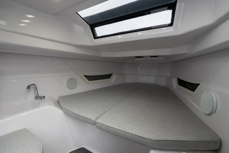 Slide: The Image of 2025 Axopar Cross Top cabin interior with skylight and modern design. - 20