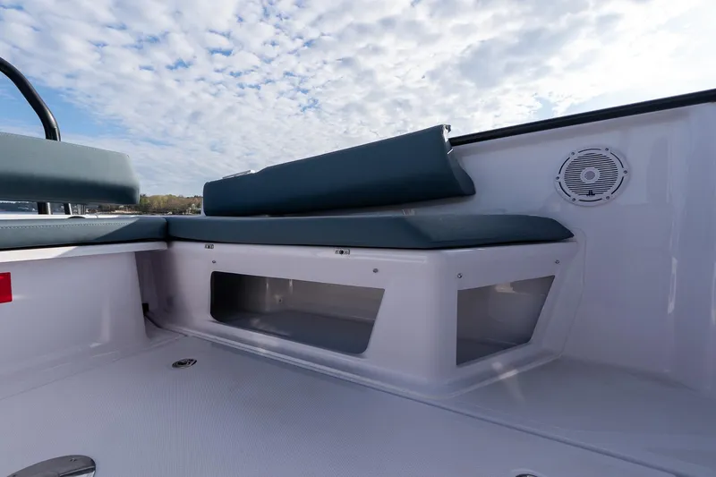 Slide: The Image of 2025 Axopar Cross Top boat interior with cushioned seating and storage compartment. - 27
