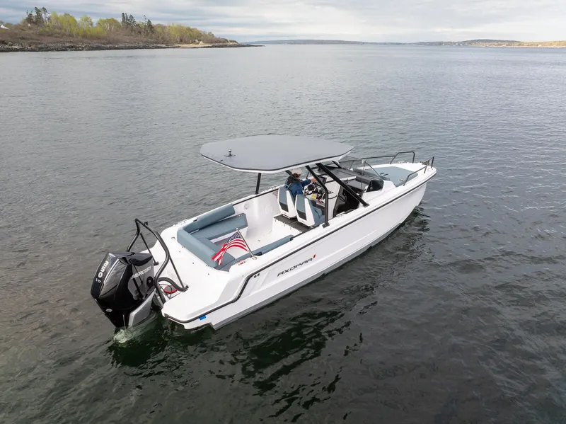 Slide: The Image of 2025 Axopar Cross Top boat on calm water, featuring sleek design and modern features. - 3