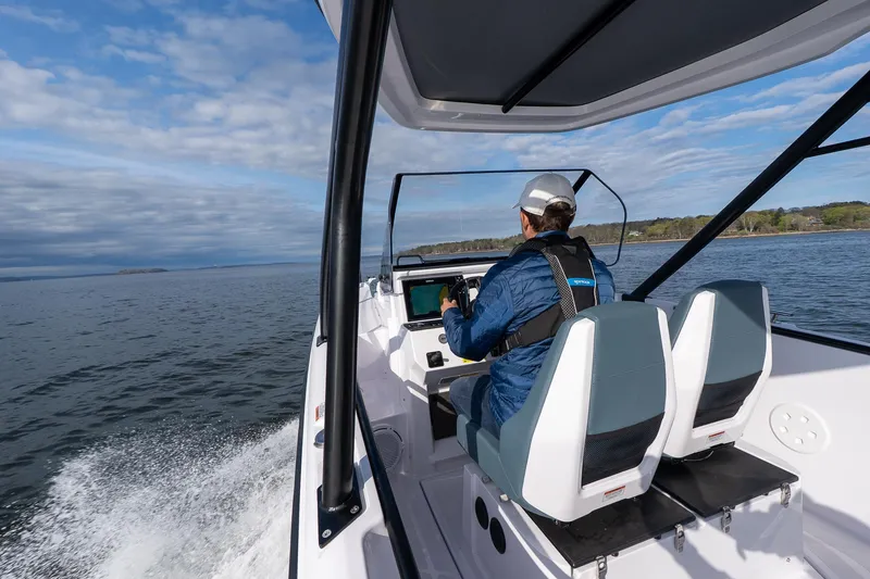 Slide: The Image of 2025 Axopar Cross Top boat cruising on open water, featuring modern design and advanced navigation. - 9