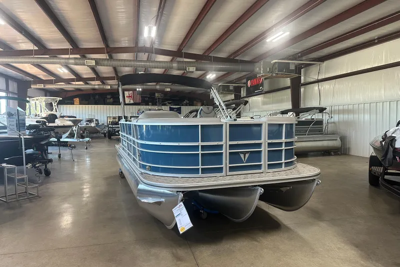 The Image of 2025 Trifecta 20RFLE2.75 pontoon boat displayed in a spacious indoor showroom. - 1