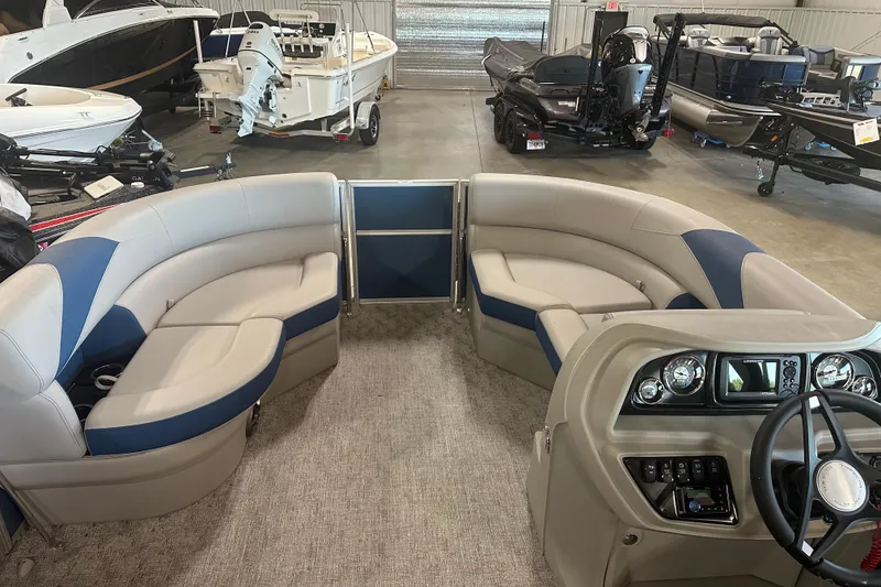 Slide: The Image of 2025 Trifecta 20RFLE2.75 pontoon boat interior with plush seating and modern dashboard. - 7