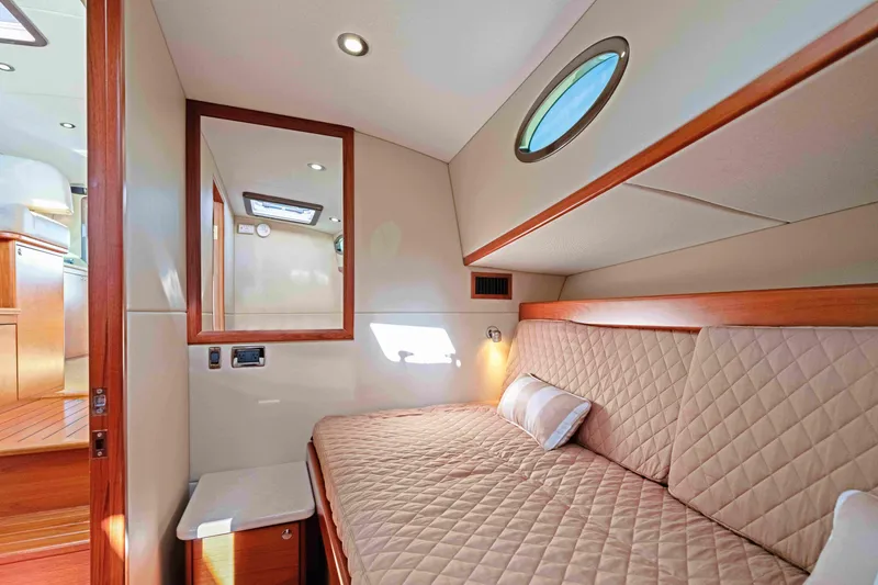 Slide: The Image of Luxurious cabin interior of 2015 Palm Beach Motor Yachts PB45 with quilted bedding. - 48