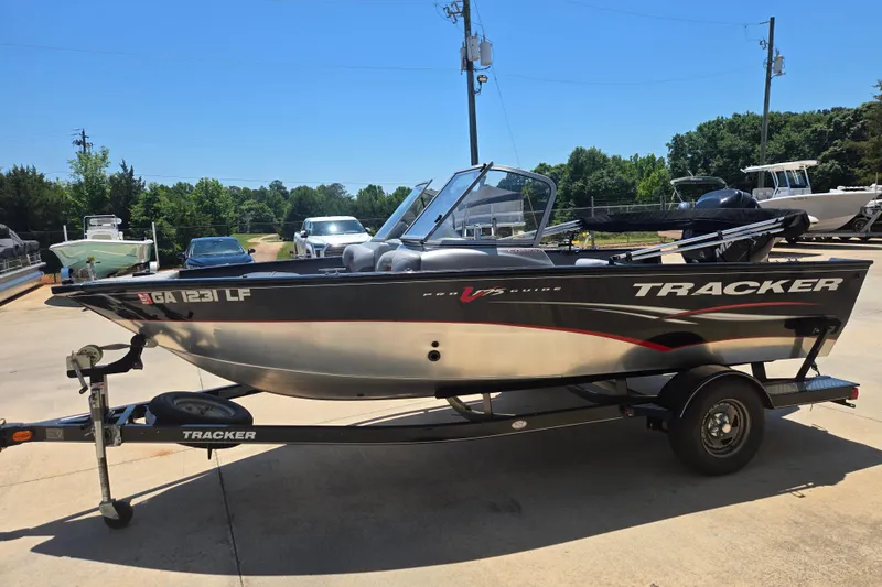 The Image of 2013 Tracker Pro Guide V-175 Combo boat on trailer in sunny outdoor setting. - 1