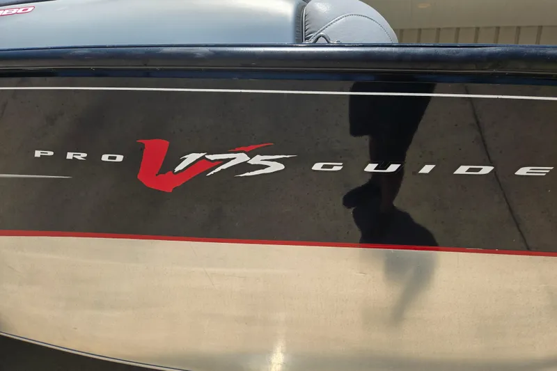 Slide: The Image of 2013 Tracker Pro Guide V-175 Combo boat logo on black and silver hull. - 10