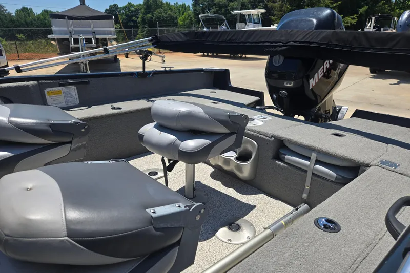 Slide: The Image of 2013 Tracker Pro Guide V-175 Combo boat interior with gray seating and Mercury outboard motor. - 3