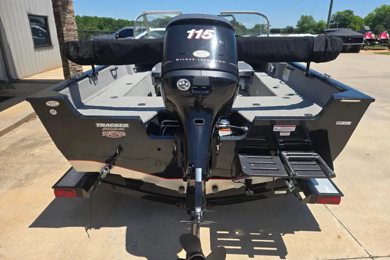 Slide: The Image of 2013 Tracker Pro Guide V-175 Combo boat with 115 horsepower engine, parked outdoors. - 4