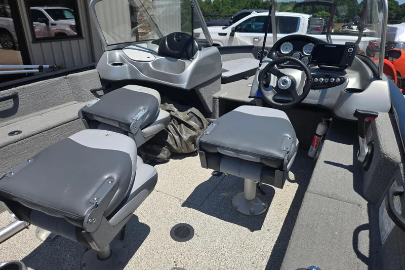 Slide: The Image of 2013 Tracker Pro Guide V-175 Combo boat interior with seating and steering console. - 5