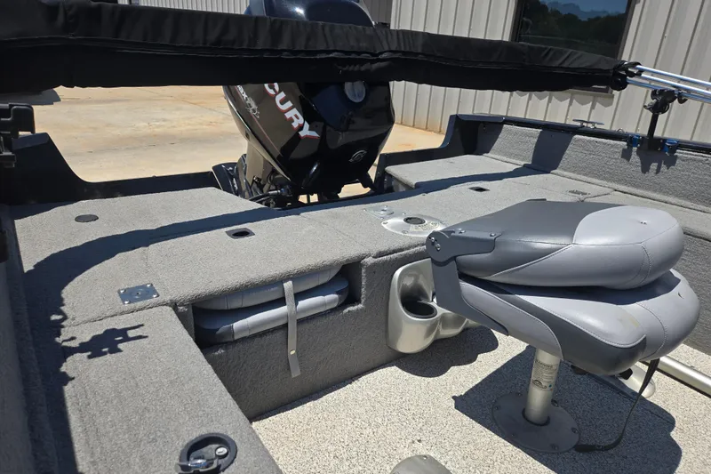 Slide: The Image of 2013 Tracker Pro Guide V-175 Combo boat interior with seating and Mercury engine. - 7