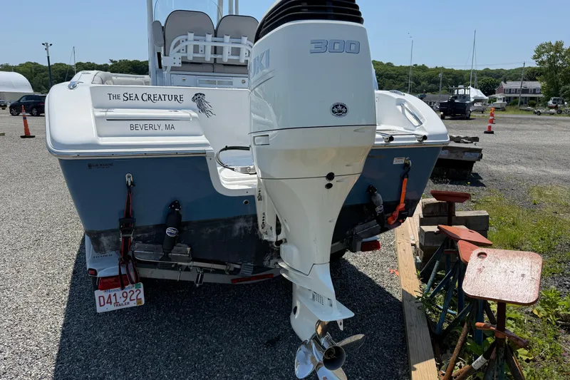 Slide: The Image of 2019 Sea Pro 239 Center Console boat with Suzuki 300 engine, parked on gravel. - 4