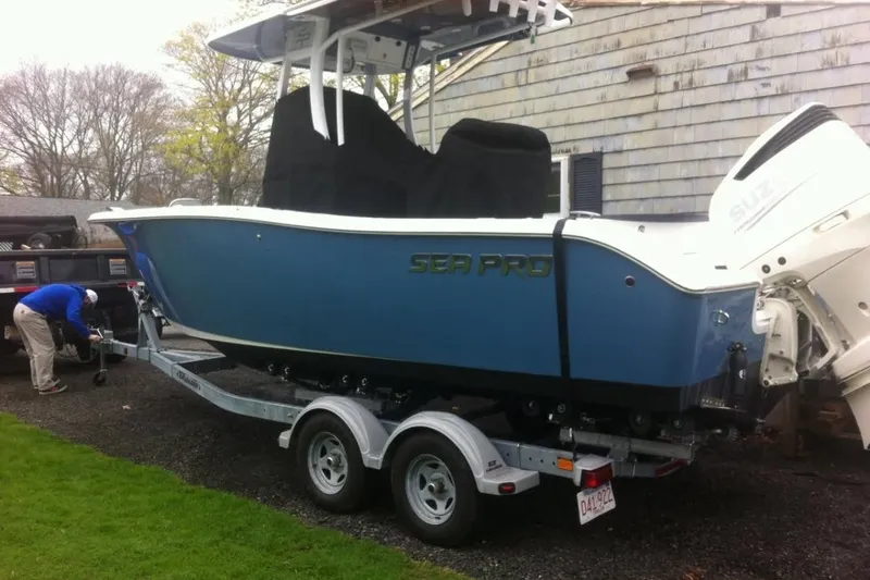 The Image of 2019 Sea Pro 239 Center Console boat on trailer, parked outdoors. - 1