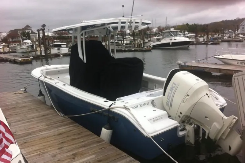 Slide: The Image of 2019 Sea Pro 239 Center Console boat docked with Suzuki outboard motor. - 4