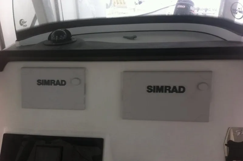 Slide: The Image of 2019 Sea Pro 239 Center Console dashboard with dual Simrad displays. - 6