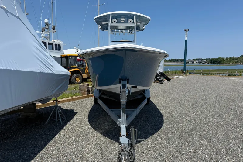 Slide: The Image of 2019 Sea Pro 239 Center Console boat on trailer, parked near waterfront. - 3