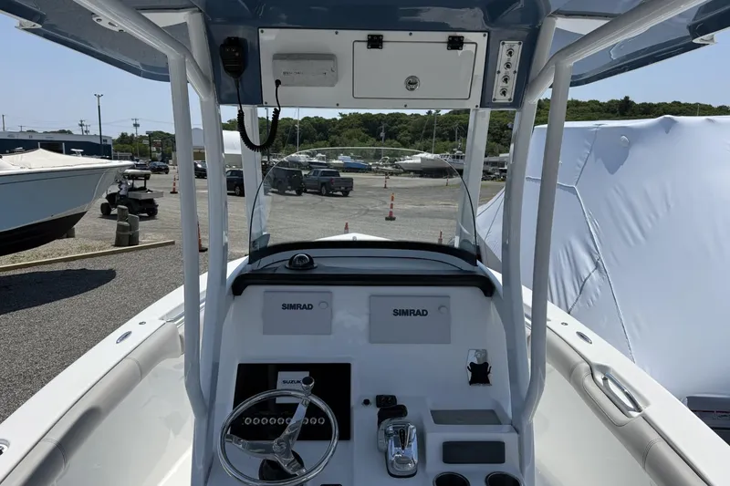 Slide: The Image of 2019 Sea Pro 239 Center Console boat dashboard with steering wheel and Simrad electronics. - 6