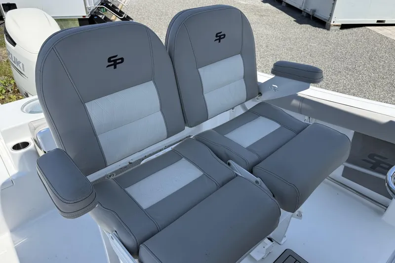 Slide: The Image of 2019 Sea Pro 239 Center Console boat seats, featuring gray and white upholstery with armrests. - 9