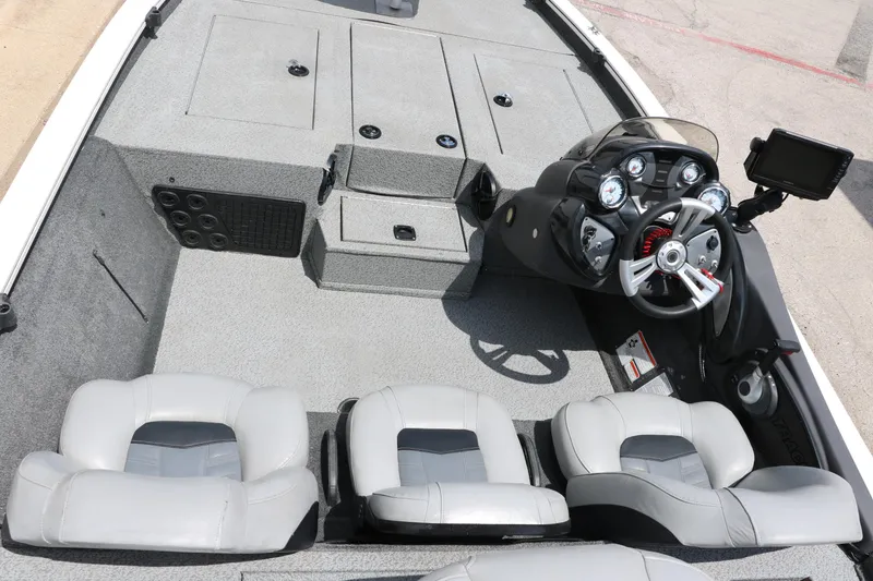 Slide: The Image of 2018 Tracker Pro Team 195 TXW boat interior with steering console and seating. - 13