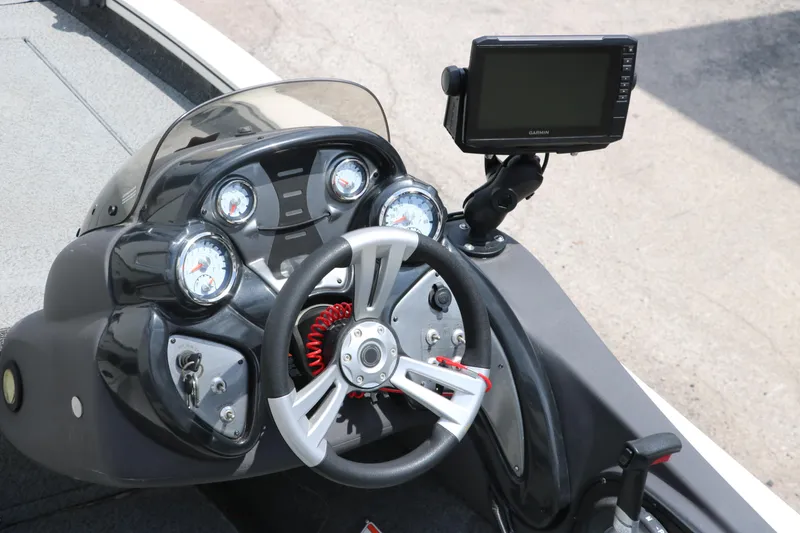 Slide: The Image of 2018 Tracker Pro Team 195 TXW boat dashboard with steering wheel and Garmin display. - 14