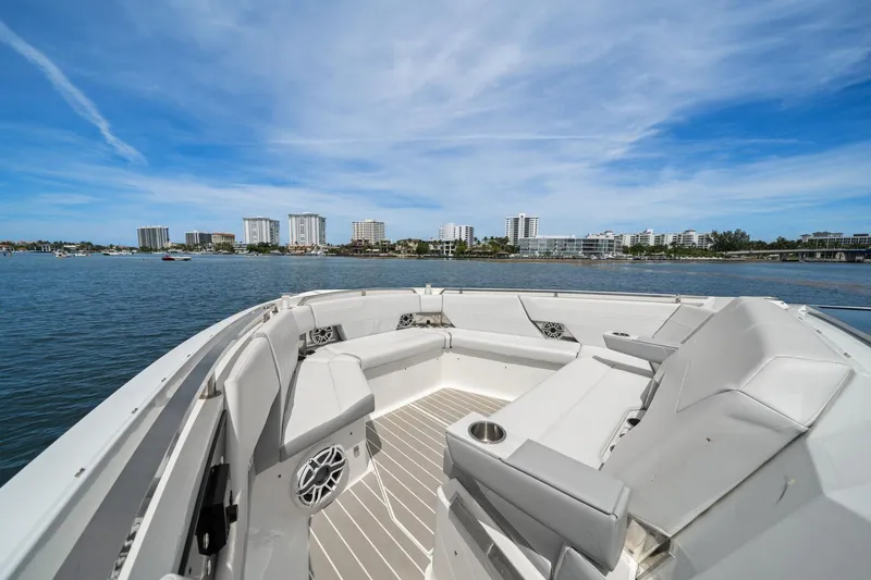 Slide: The Image of 2025 Formula 500 Super Sport Crossover boat with luxurious seating, overlooking a coastal skyline. - 13