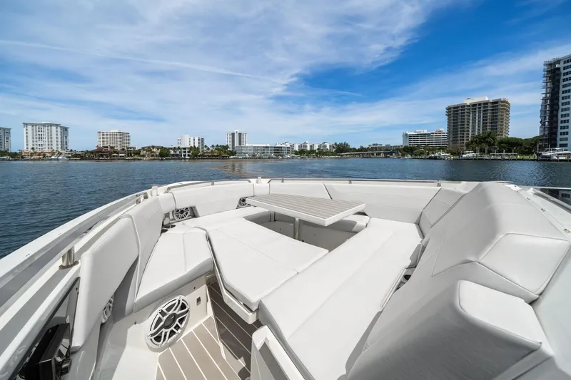 Slide: The Image of 2025 Formula 500 Super Sport Crossover boat with luxurious seating, overlooking waterfront cityscape. - 14