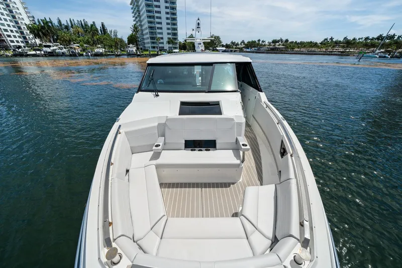 Slide: The Image of 2025 Formula 500 Super Sport Crossover boat with luxurious seating on calm water. - 16