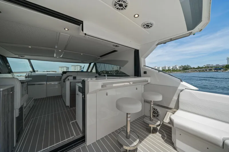 Slide: The Image of Luxurious interior of 2025 Formula 500 Super Sport Crossover yacht with modern seating and scenic water view. - 23