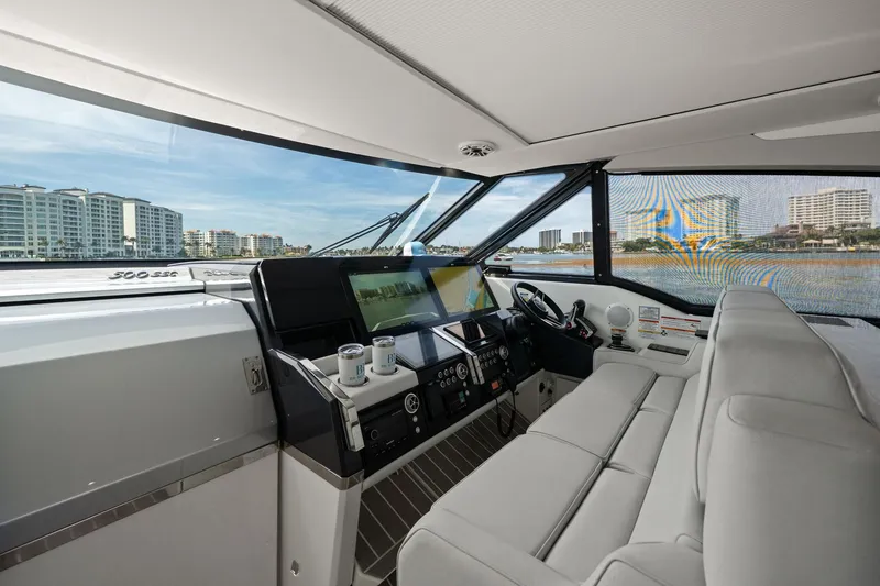 Slide: The Image of Interior of 2025 Formula 500 Super Sport Crossover yacht with modern dashboard and cityscape view. - 38