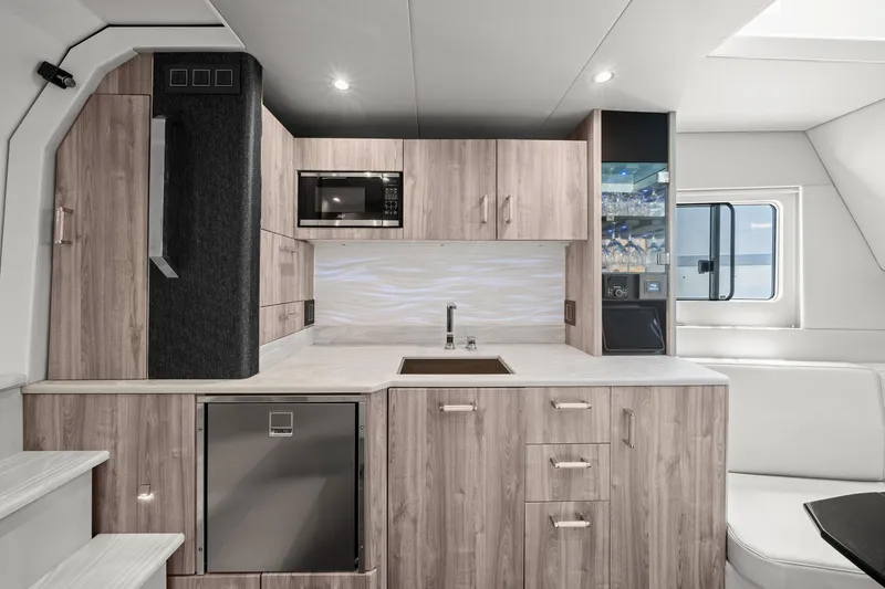Slide: The Image of Modern kitchen interior in 2025 Formula 500 Super Sport Crossover boat, featuring sleek cabinetry and appliances. - 46