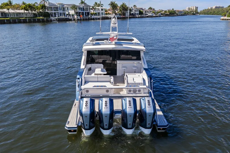Slide: The Image of 2025 Formula 500 Super Sport Crossover boat with quad engines on a scenic waterway. - 5