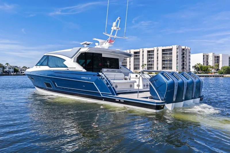 Slide: The Image of 2025 Formula 500 Super Sport Crossover yacht cruising on a sunny day near waterfront buildings. - 6