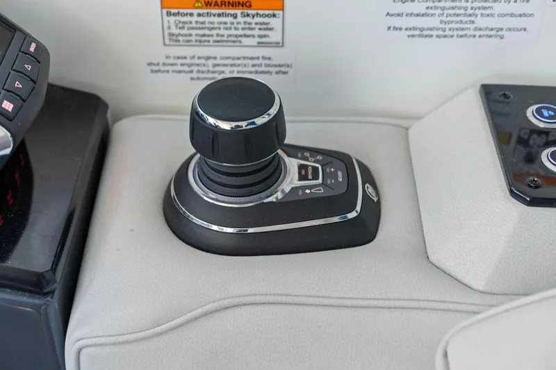 Slide: The Image of Control panel of 2025 Formula 500 Super Sport Crossover with joystick and warning label. - 60