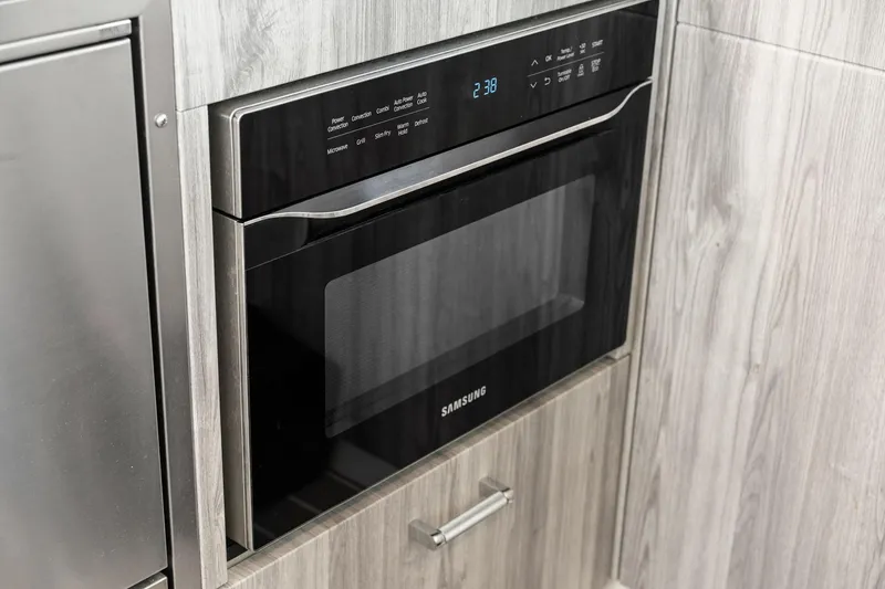 Slide: The Image of Built-in Samsung microwave in modern kitchen, part of 2025 Formula 500 Super Sport Crossover. - 63