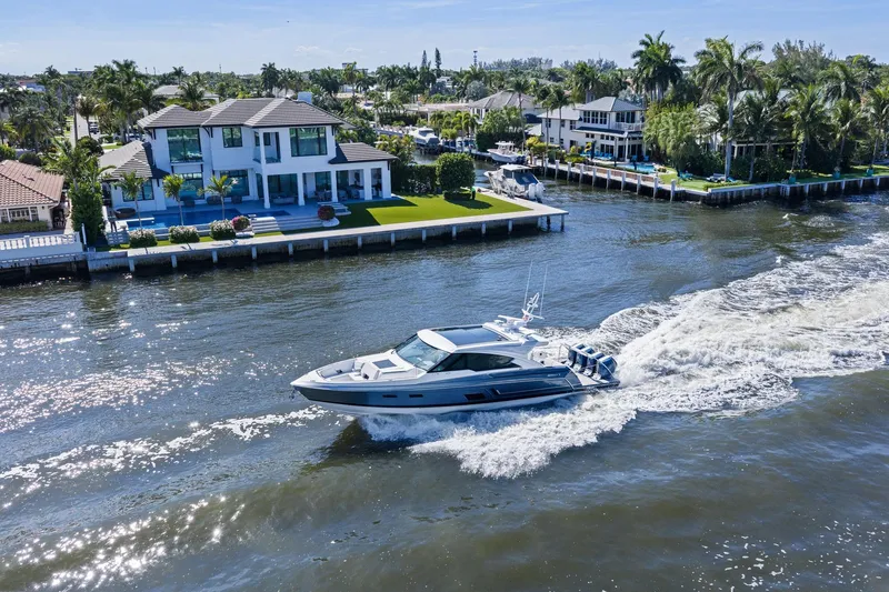 Slide: The Image of 2025 Formula 500 Super Sport Crossover cruising near luxury waterfront homes. - 66