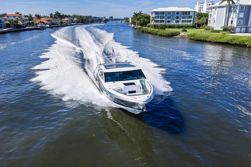 Slide: The Image of 2025 Formula 500 Super Sport Crossover cruising on a scenic waterway. - 68