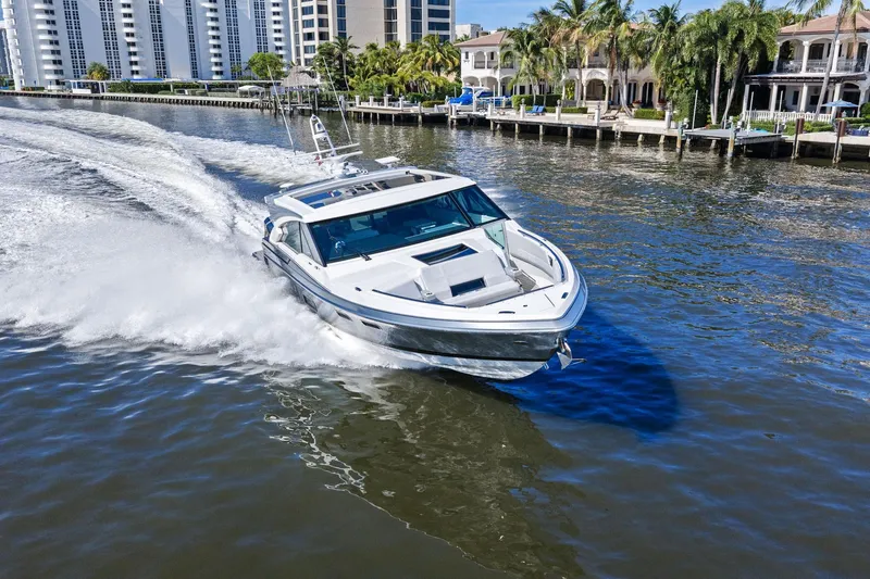 Slide: The Image of 2025 Formula 500 Super Sport Crossover cruising on a scenic waterway. - 70