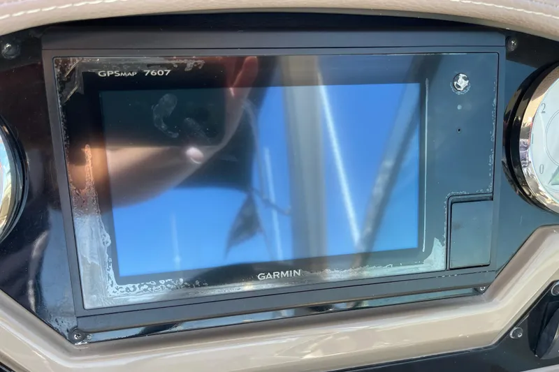 Slide: The Image of Garmin GPSMAP 7607 on 2016 Regal 28 Express dashboard, reflecting sunlight. - 11