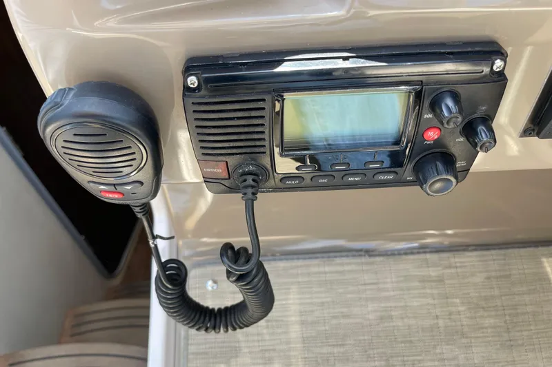 Slide: The Image of VHF radio system on 2016 Regal 28 Express boat dashboard. - 13