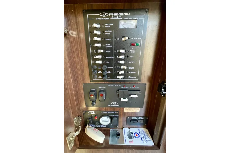 Slide: The Image of Electrical control panel of 2016 Regal 28 Express boat, featuring switches and gauges. - 19