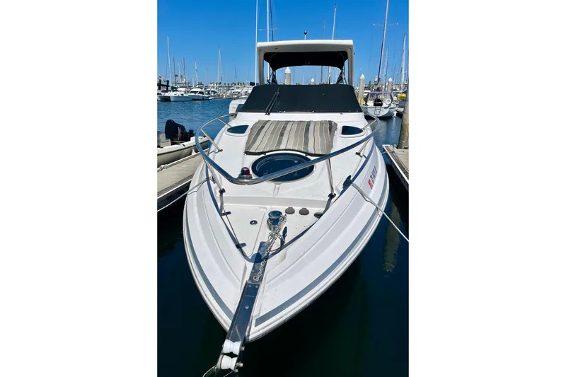 Slide: The Image of 2016 Regal 28 Express boat docked at marina, featuring sleek design and spacious deck. - 2