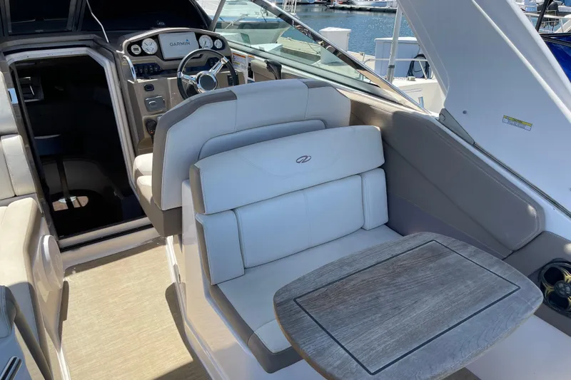 Slide: The Image of Interior of a 2016 Regal 28 Express boat with plush seating and wooden table. - 3