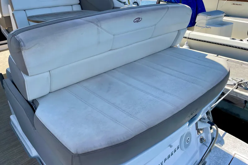 Slide: The Image of 2016 Regal 28 Express boat with cushioned seating at the dock. - 7