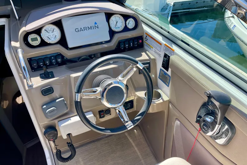 Slide: The Image of Cockpit of 2016 Regal 28 Express boat with Garmin navigation system and steering wheel. - 9