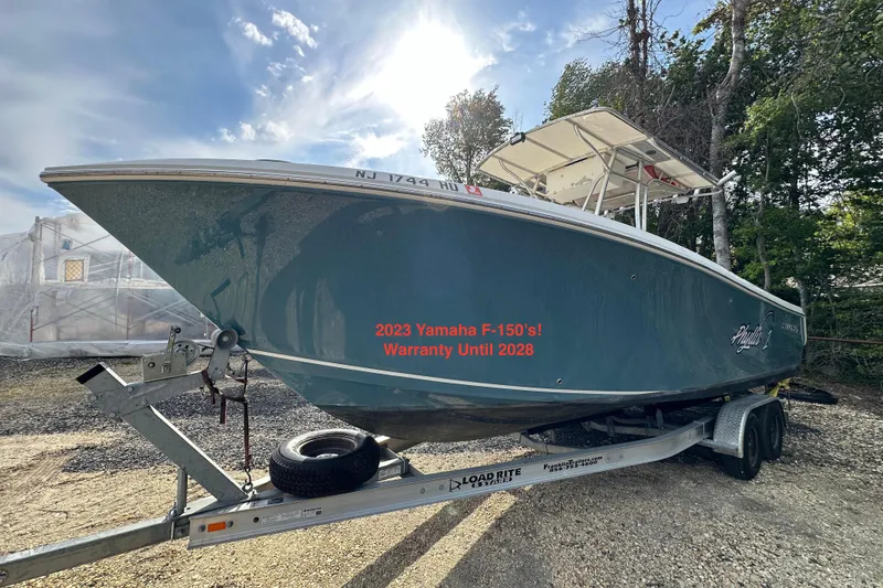 The Image of 2011 Sailfish 2660 CC boat on trailer, featuring 2023 Yamaha F-150 engines with warranty until 2028. - 0