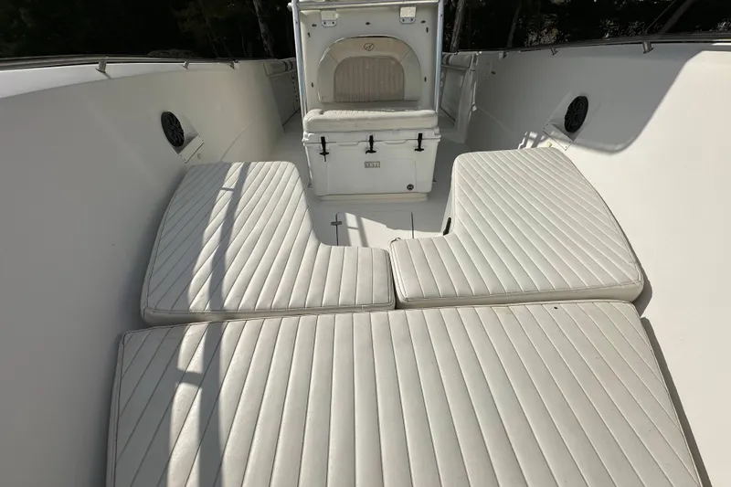 Slide: The Image of 2011 Sailfish 2660 CC boat interior with cushioned seating and storage compartment. - 12