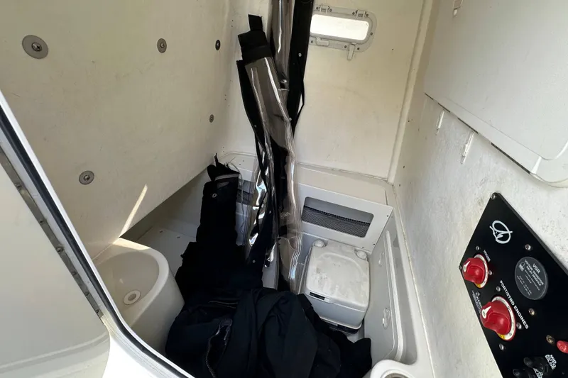 Slide: The Image of Interior of 2011 Sailfish 2660 CC boat cabin with storage and control panel. - 16